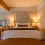 An image of a bed from one of Pine Ridge Inn's room