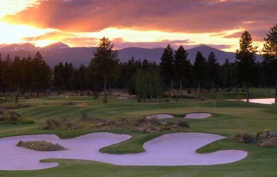 Sunset over a golf course with mountains and trees in the background in Central Oregon.