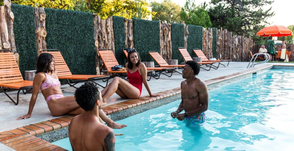 A group of people enjoying a poolside gathering, soaking up the sun and relaxing in Central Oregon.