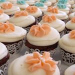 Chocolate cupcakes with white and orange icing