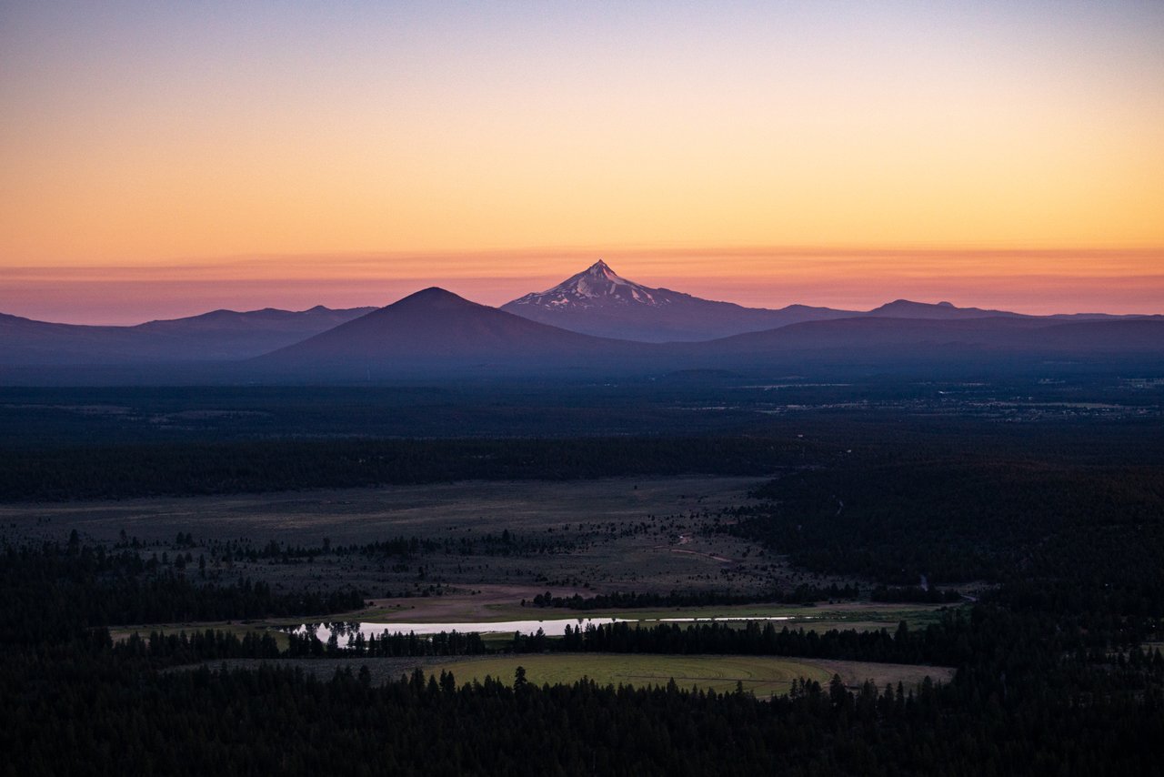 Sun setting over a mountain peak in the Central Oregon region.