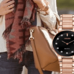 Photo of a watch with a background showing brown bag and scarf worn by a model