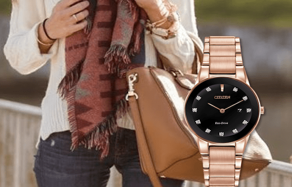 Photo of a watch with a background showing brown bag and scarf worn by a model