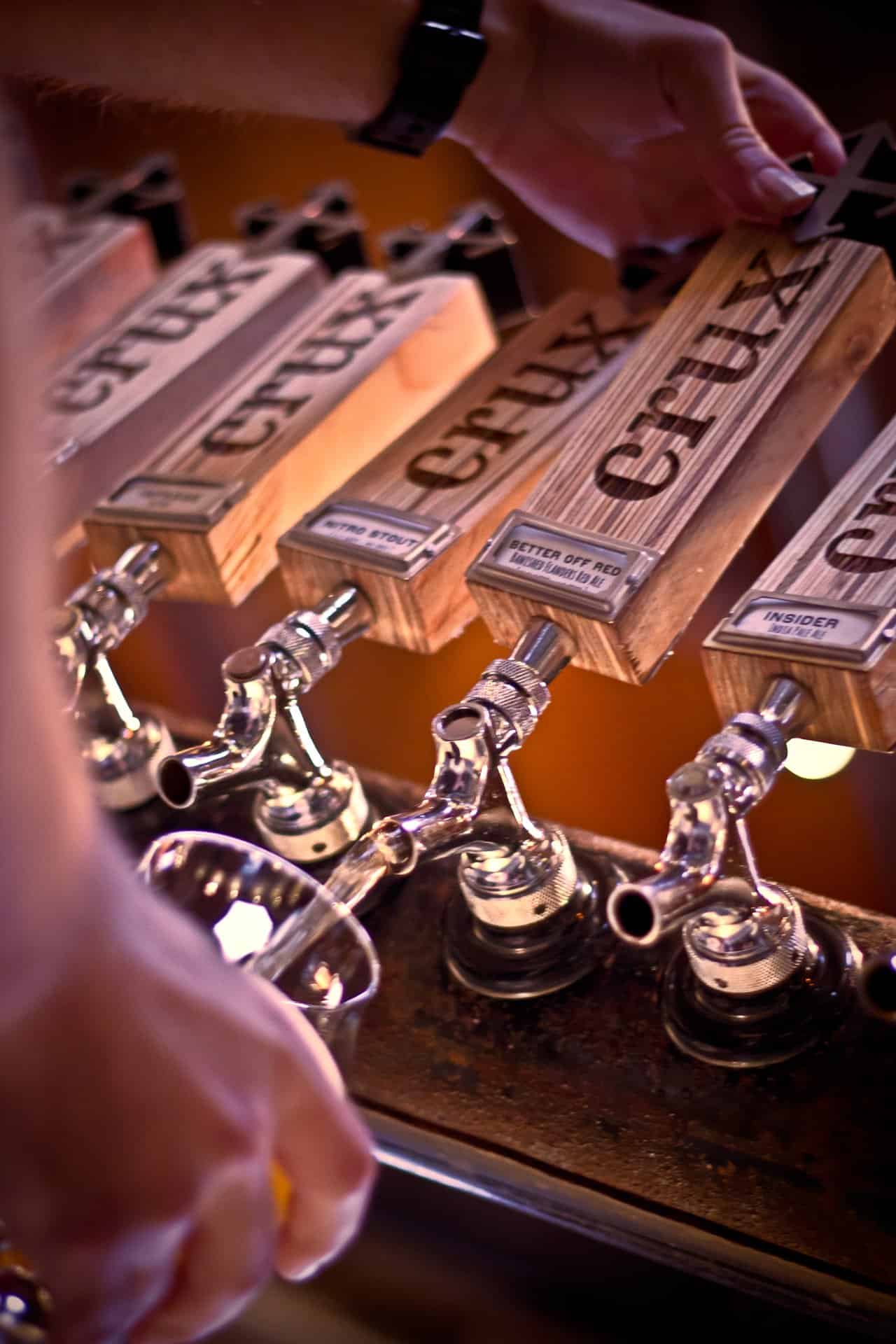 a couple standing at the bar, enjoying cidars at Tumalo Cider