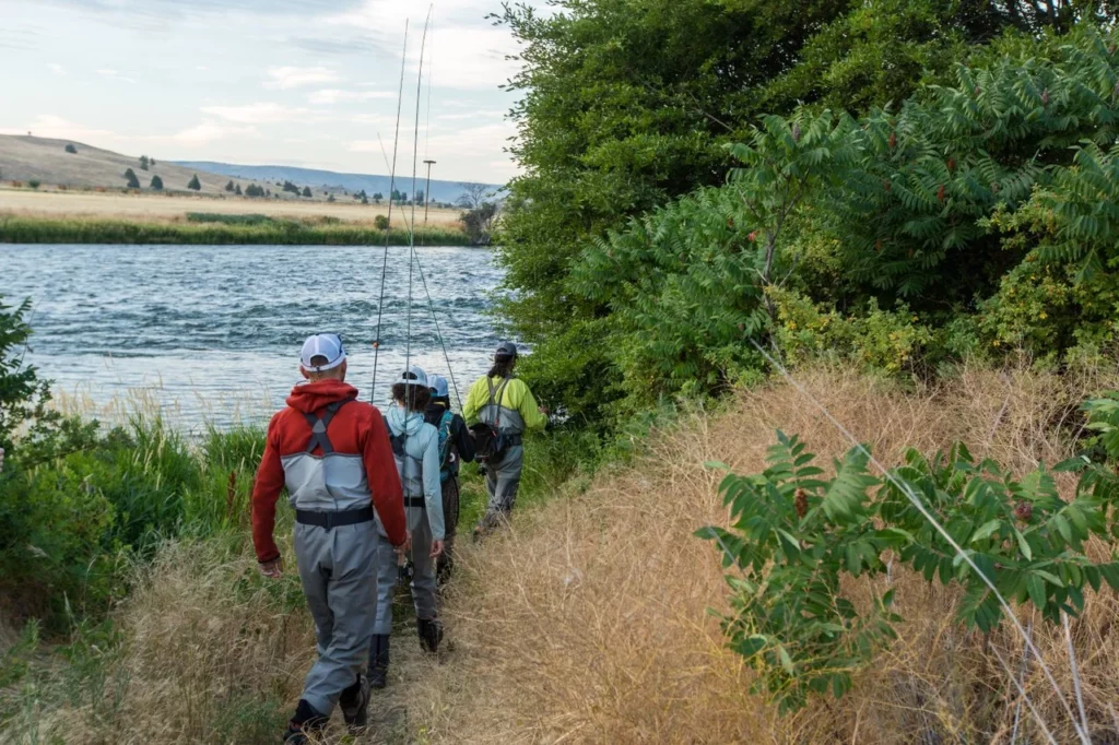  a group of anglers following their guide to the river.