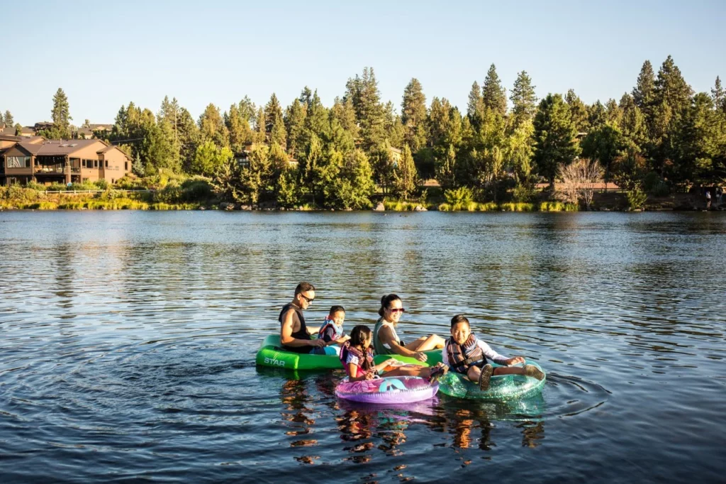 A family enjoys tubing down the Deschutes River.