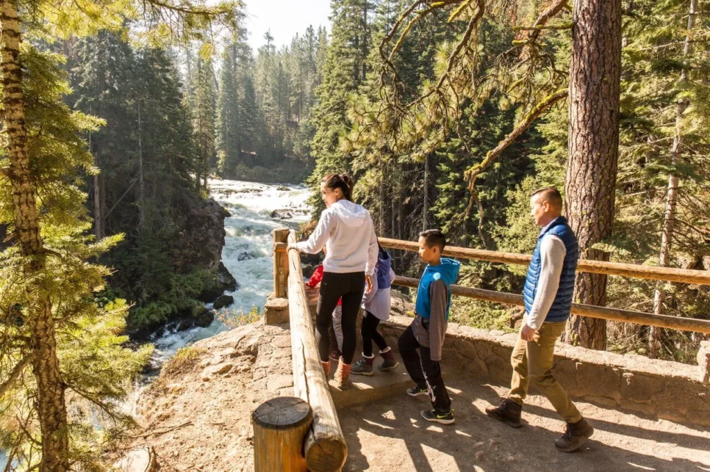 a family takes in the view of the river at Benham Falls