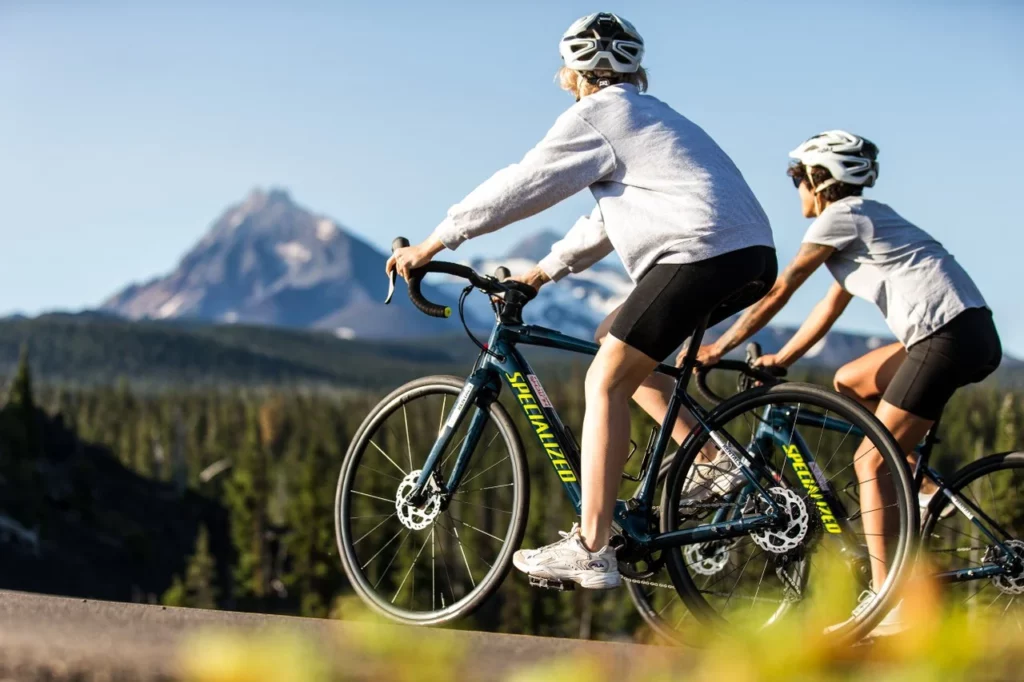 Two people road cycle on an Oregon Scenic Byway.