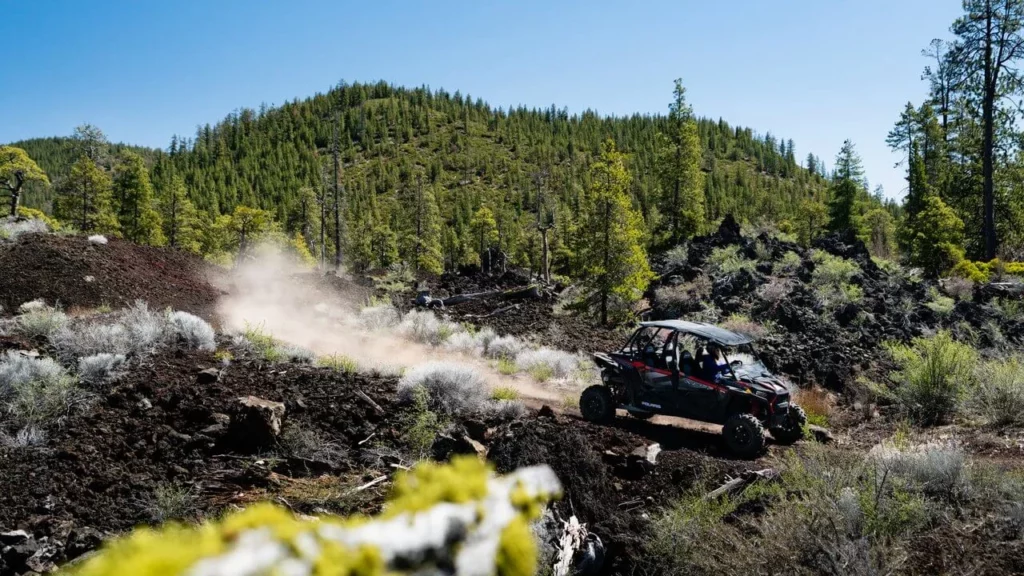 An ATV cruises through the high desert. 