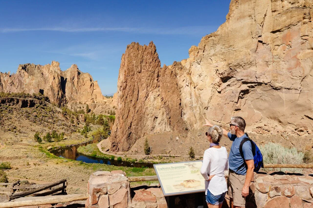 two hikers admire the view of smith rock