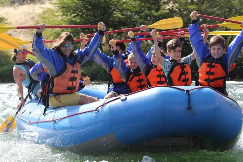 A group of people have fun while whitewater rafting