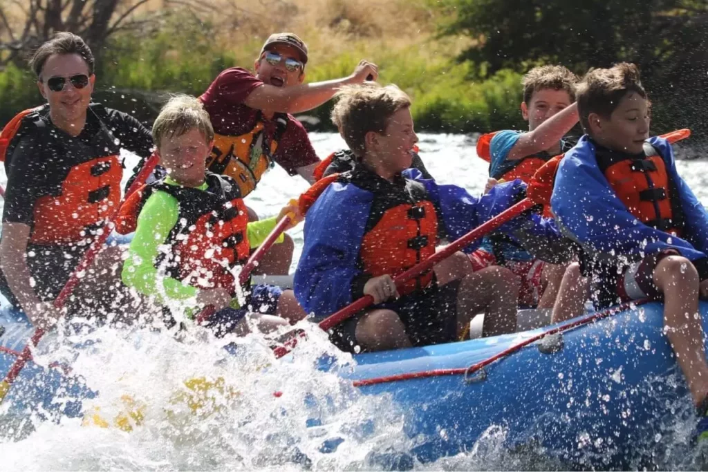 A group gets splashed while whitewater rafting