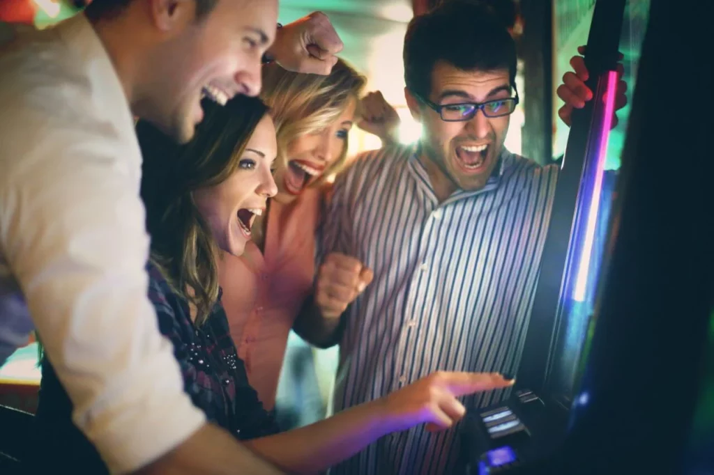 People laugh while playing in a casino. 