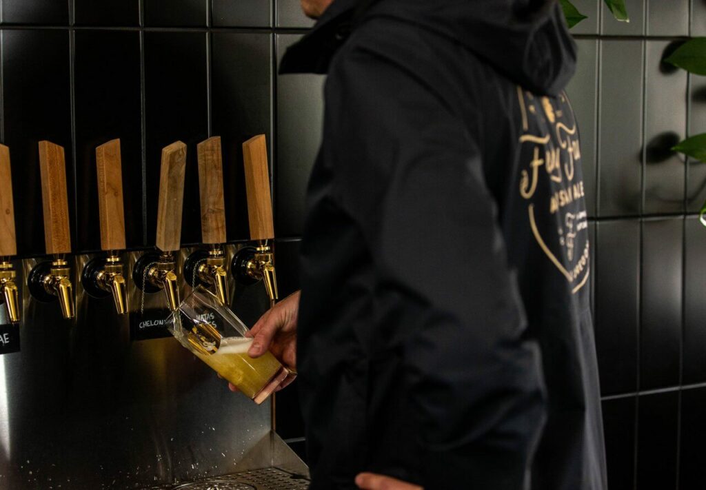 Someone pours a beer at Funky Fauna in Oregon.