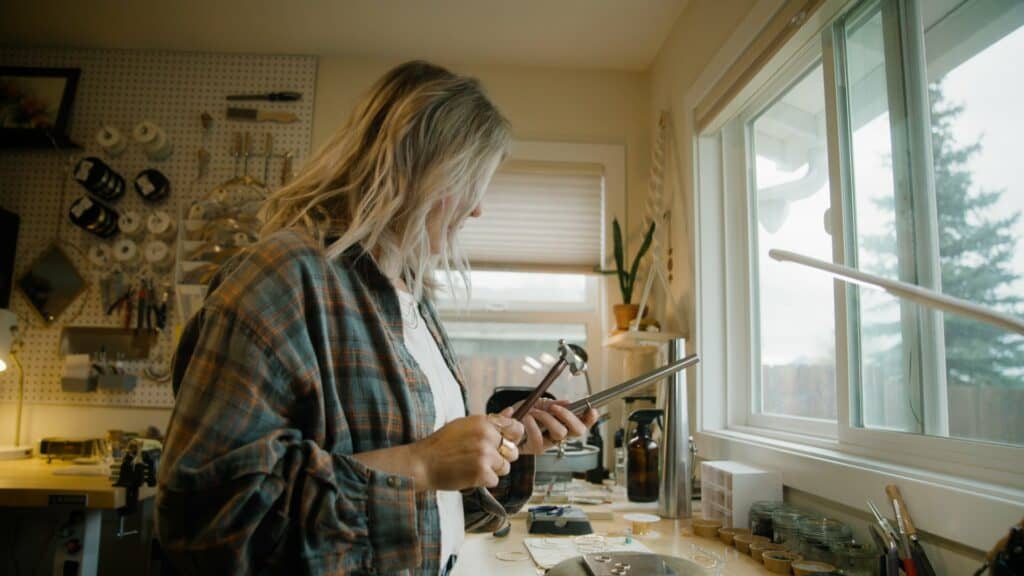 A woman makes jewelry.