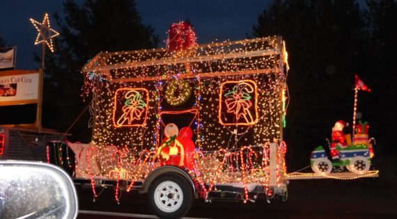 A festive Christmas parade float adorned with twinkling lights and holiday decorations in Central Oregon.