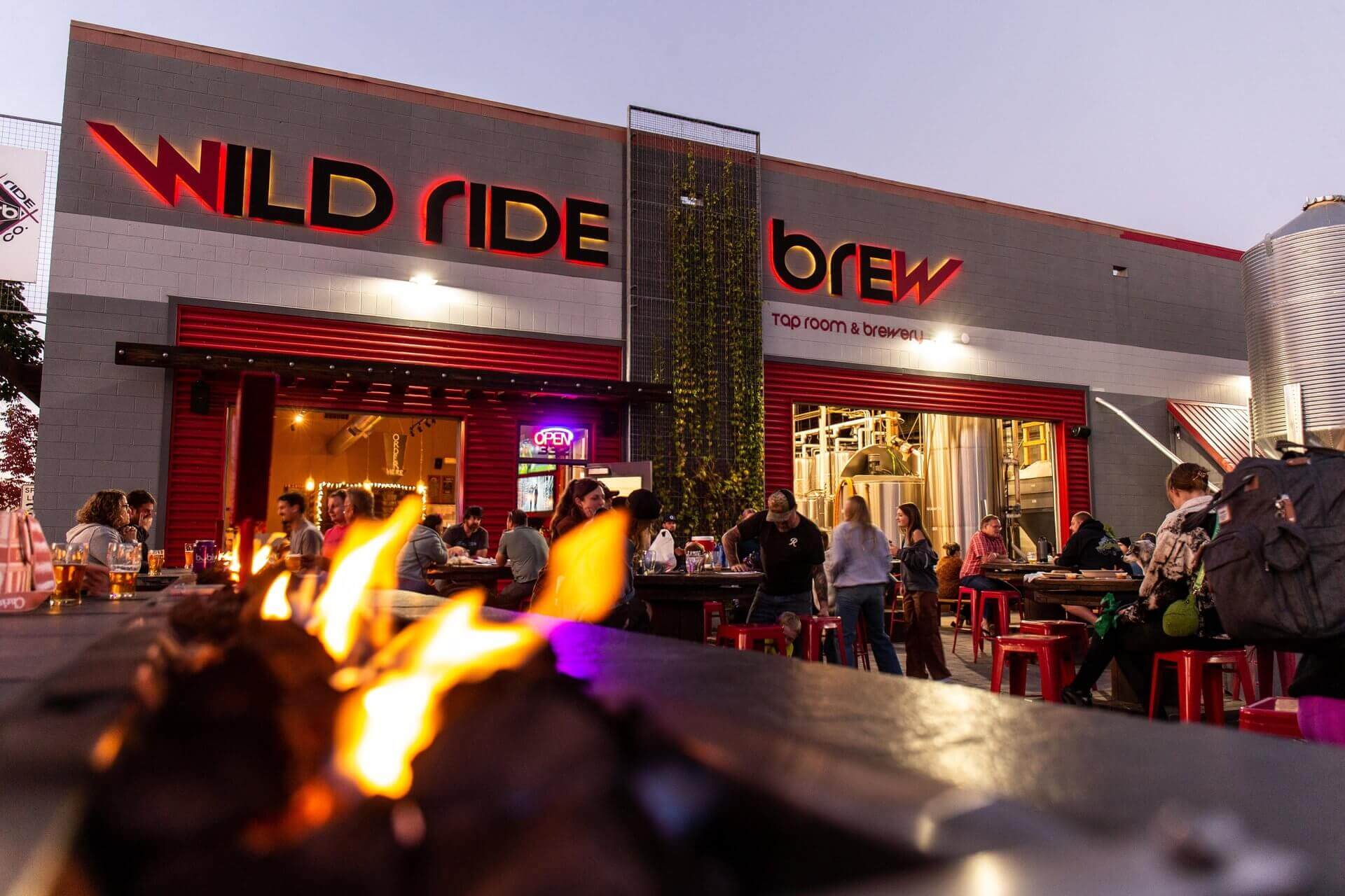 A lively tap room and brewery with a vibrant atmosphere, featuring a fire pit and outdoor seating in Central Oregon.