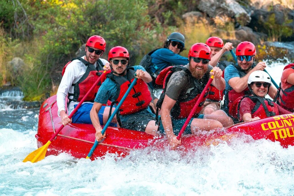 A bachelor party enjoys a whitewater rafting trip with Sun Country Tours