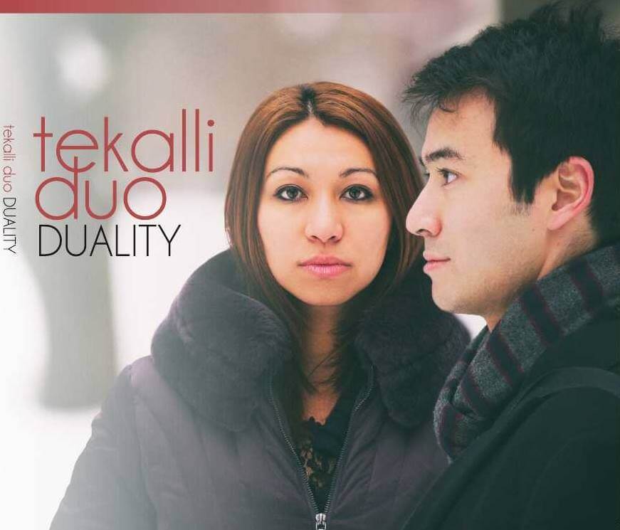 A couple in winter attire, with a woman in a dark coat and a man in a scarf, standing close together in Central Oregon.