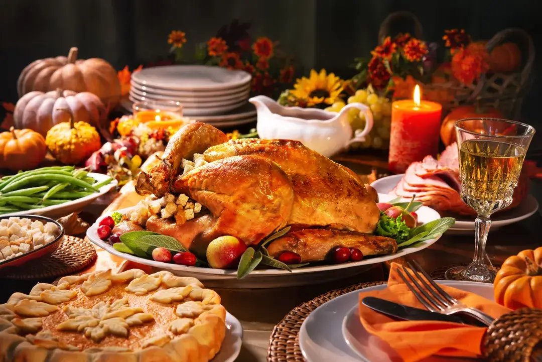 A lavish Thanksgiving table setting featuring a roasted turkey, pies, and seasonal decorations in Central Oregon.