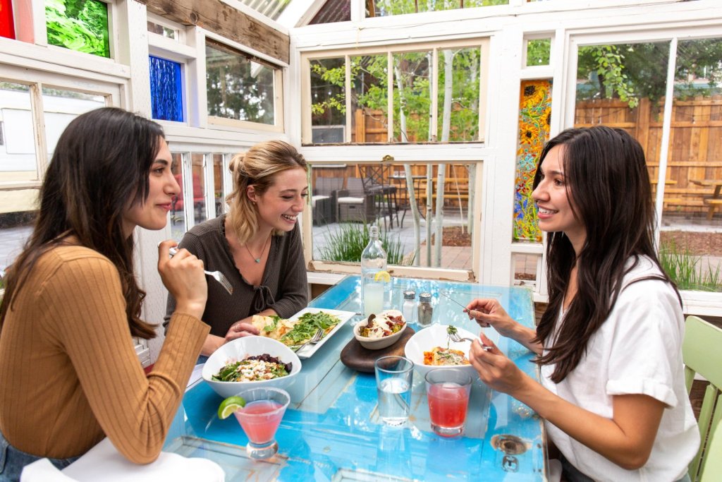 Group of friends dining at The Open Door restaurant in Sisters, Oregon