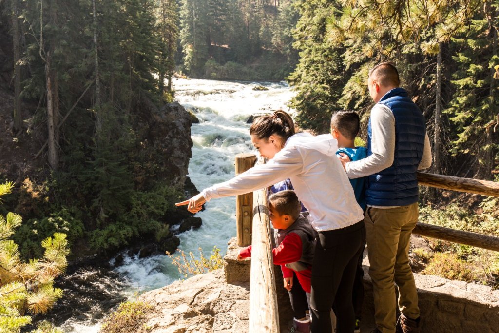 Family of hikers at a viewpoint overlooking Benham Falls near Bend, Oregon