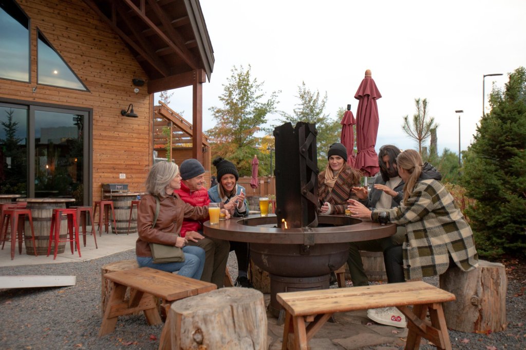 A group of people warms up and enjoys a beer at Crosscut Warming hut