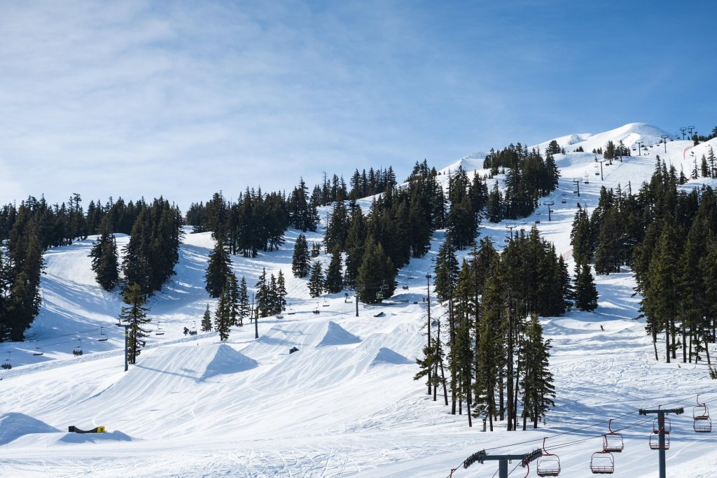 A snowy mountain resort with ski lifts and trees in Central Oregon.