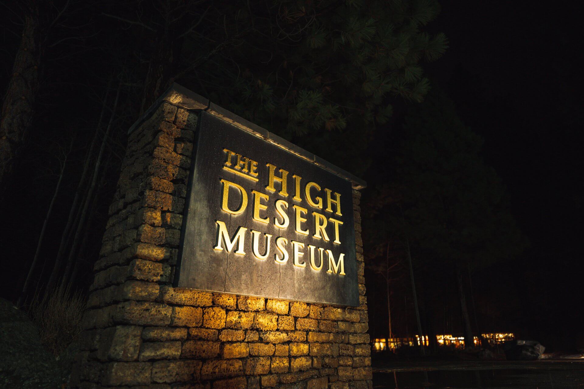 A illuminated sign for The High Desert Museum at night in Central Oregon.