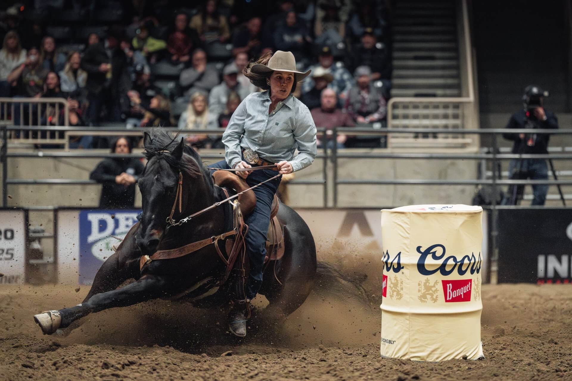 A woman on a horse skillfully maneuvers around a barrel during a rodeo event in Central Oregon.