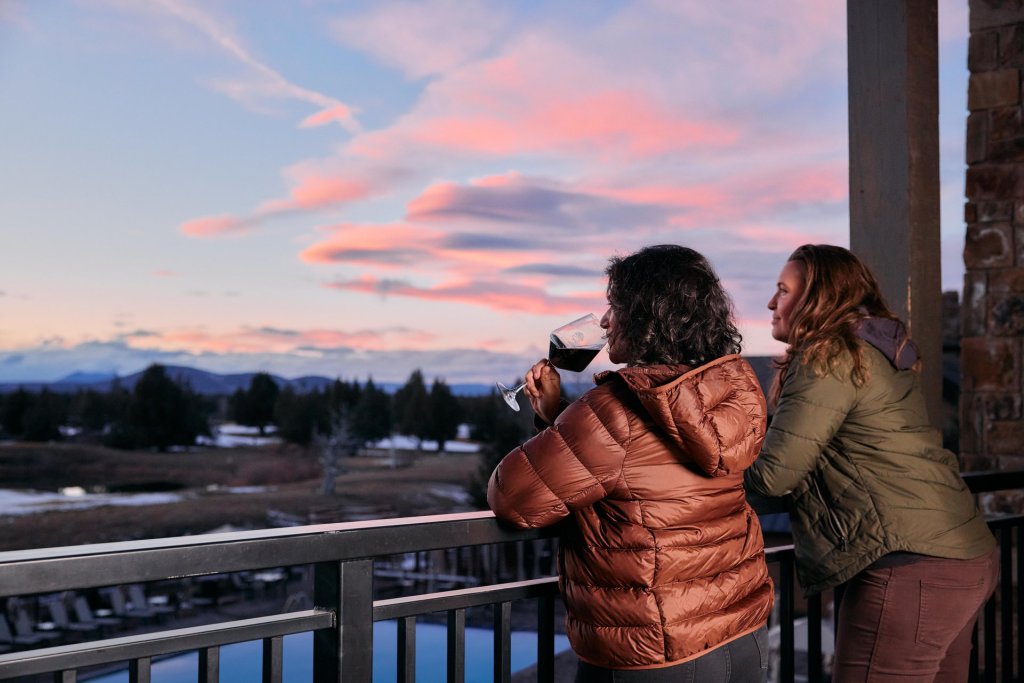 A couple enjoys a glass of wine at Juniper Preserve resort outside of Bend, Oregon