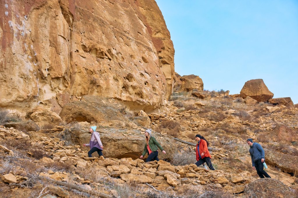 Family of hikers ascending the Misery Ridge Trail at Smith Rock State Park near Terrebonne, Oregon