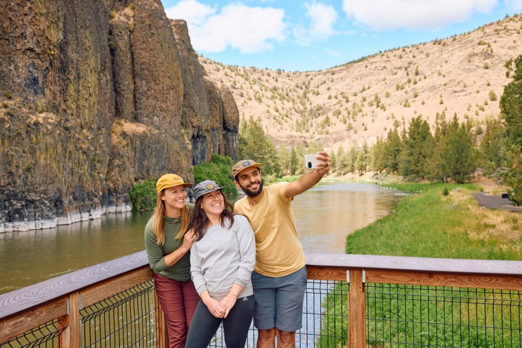  Hikers taking a selfie next to the Crooked River on the Chimney Rock Trail near Terrebonne, Oregon