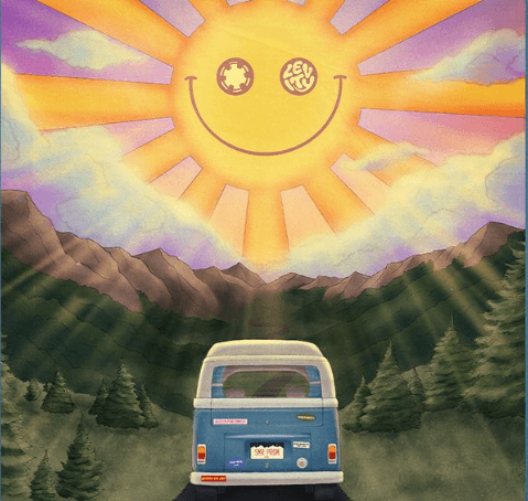 A vintage van drives through a scenic mountain landscape under a vibrant sunset in Central Oregon.