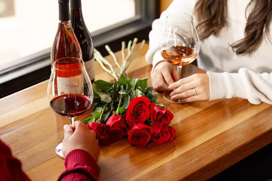 A romantic scene with wine and roses, capturing a moment of intimacy and connection in Central Oregon.