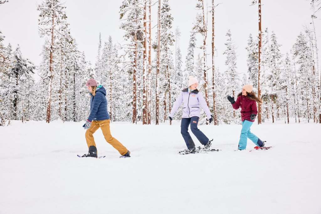 Three snowshoers in a snowy forest near Bend, Oregon