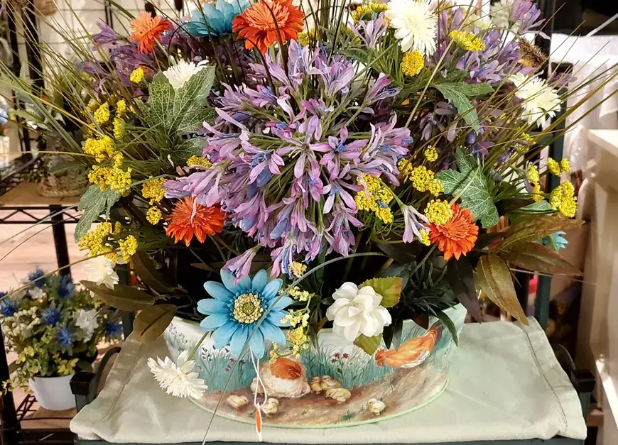 A vibrant floral arrangement featuring a variety of colorful flowers in a decorative container in Central Oregon.