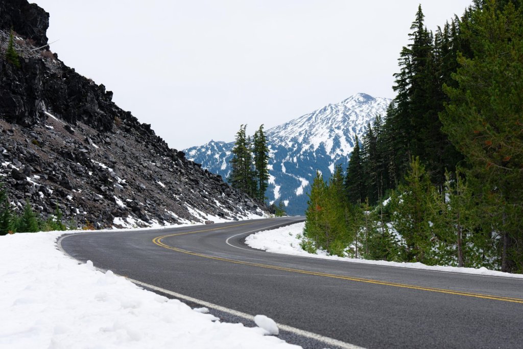 Snowy winter roadway, with Mount Bachelor rising in the background, near Bend, Oregon