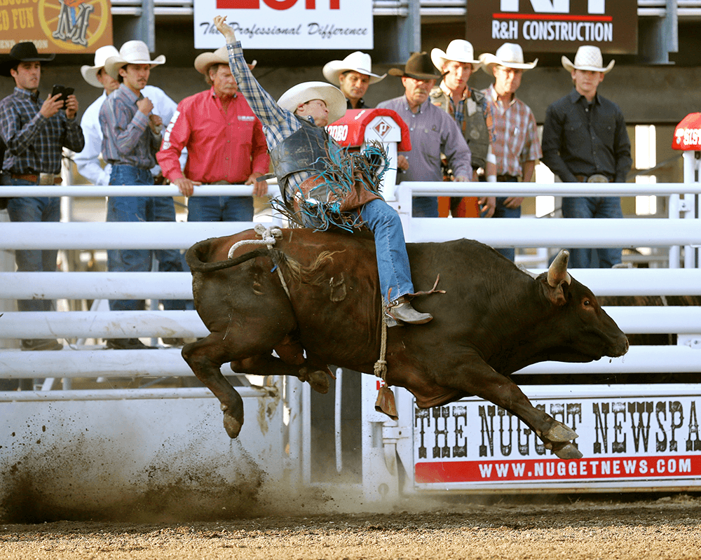 A rodeo rider is being bucked off a charging bull in a thrilling rodeo event in Central Oregon.