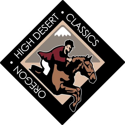 A jockey in red silks rides a brown horse over a jump in Central Oregon.
