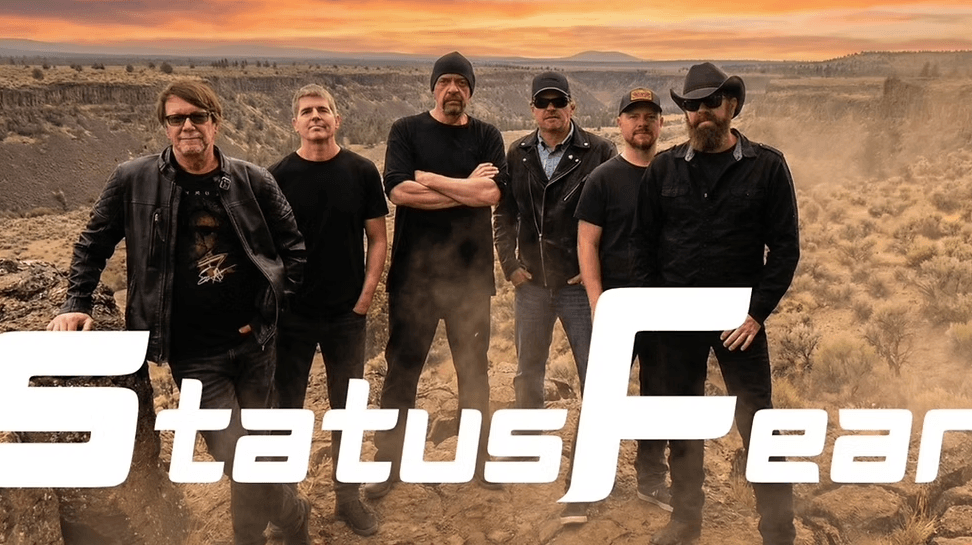 A group of six men in black clothing pose in a desert landscape at sunset in Central Oregon.