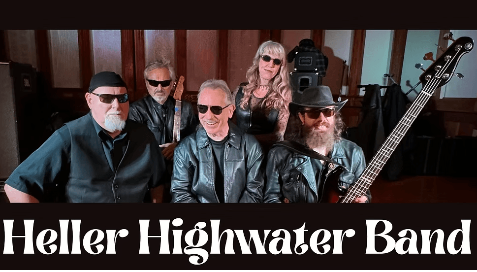 A group of five musicians, dressed in leather and sunglasses, pose together with their instruments in Central Oregon.