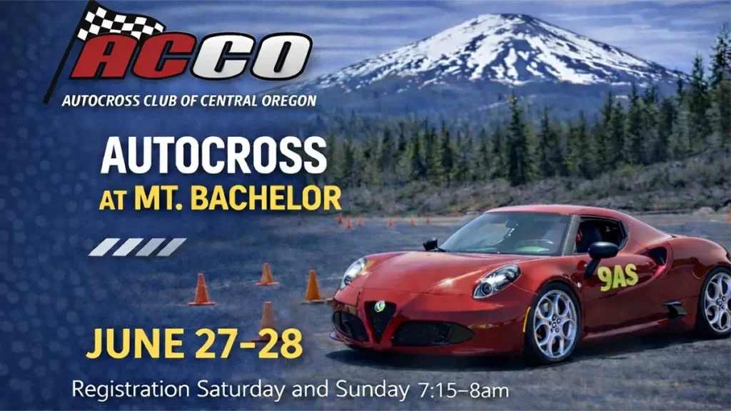 A red sports car with the number 9AS on its side navigates an autocross course marked by orange cones, with a snow-capped mountain in the background in Central Oregon.