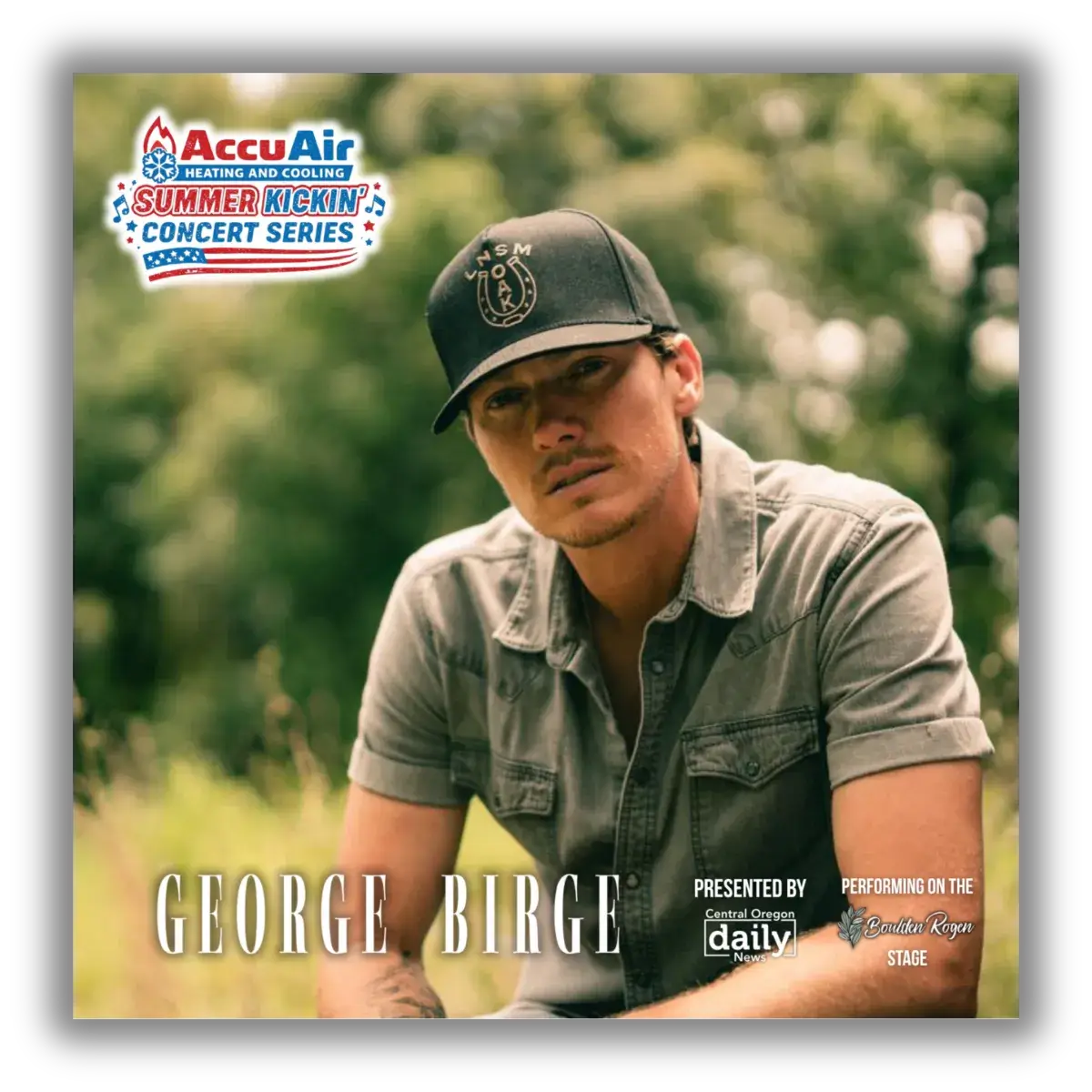 George Birge, a country music artist, is seated outdoors wearing a black cap and a denim shirt, with a backdrop of lush greenery in Central Oregon.