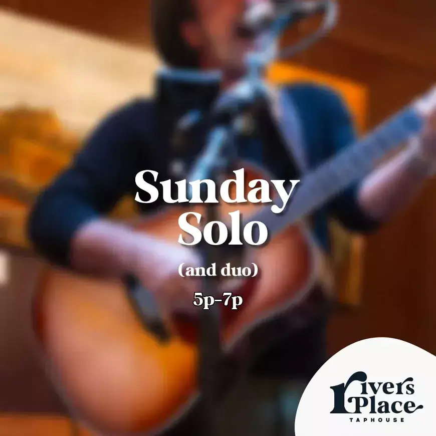 A musician performing solo with an acoustic guitar at a taphouse in Central Oregon.