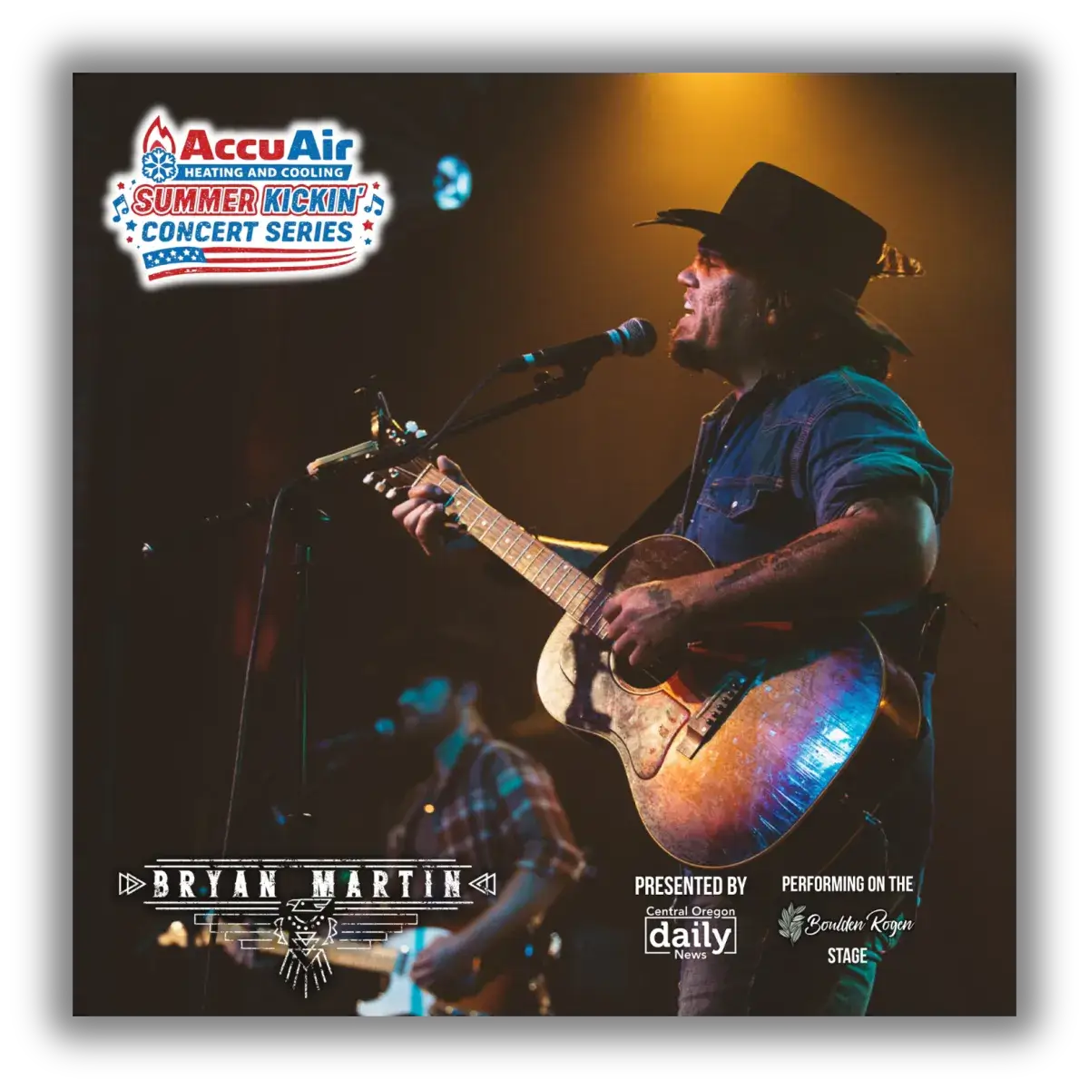 A musician wearing a cowboy hat passionately sings into a microphone while playing an acoustic guitar on stage in Central Oregon.