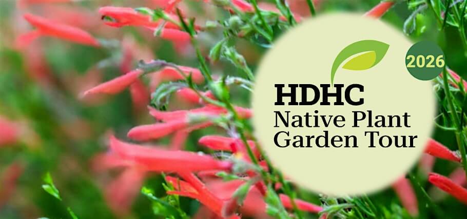 A vibrant garden filled with native red flowers and lush green foliage in Central Oregon.