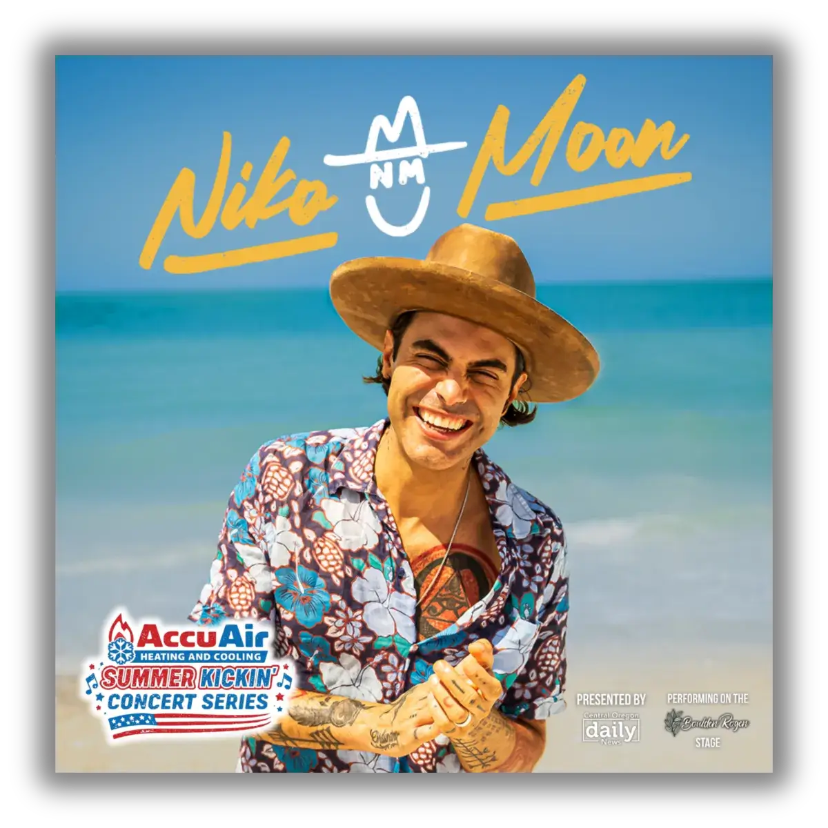 A man in a floral shirt and cowboy hat smiles on a beach with the ocean in the background in Central Oregon.