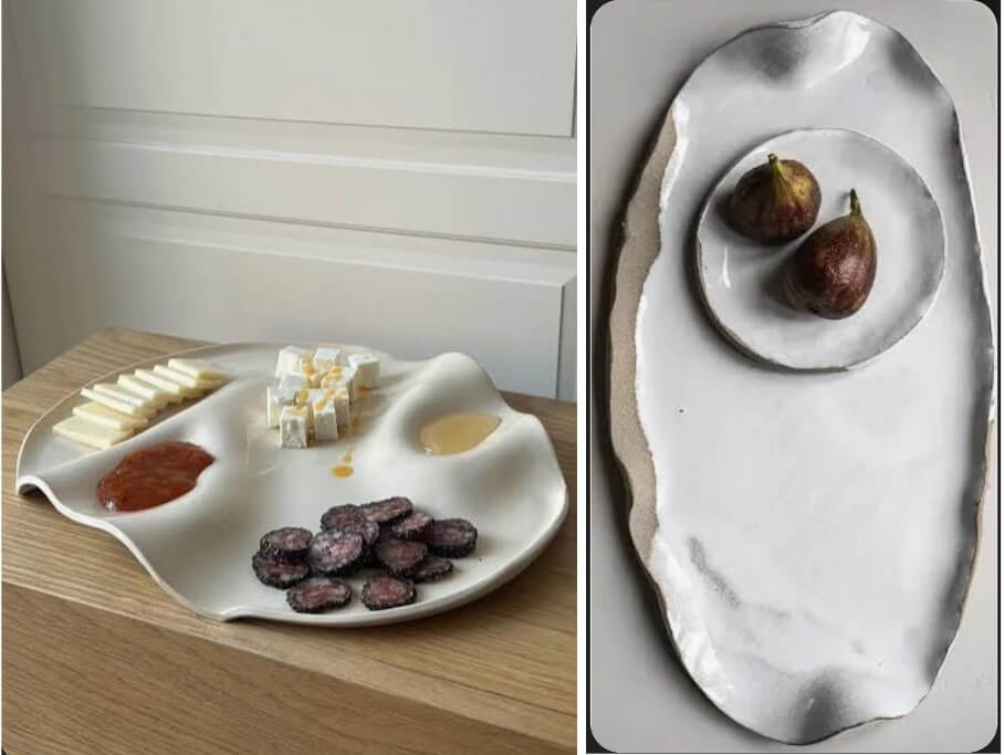A unique, irregularly shaped white ceramic plate holds an assortment of gourmet foods, including cheese, dried fruits, and cured meats, arranged in distinct sections in Central Oregon.