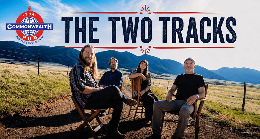 Four musicians, two men and two women, sit on folding chairs in a grassy field with mountains in the background, suggesting a relaxed, outdoor setting for their performance in Central Oregon.